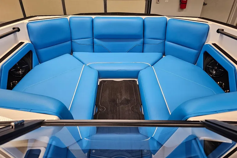 Slide: The Image of 2026 Moomba Max boat interior with blue cushioned seating and black flooring. - 15