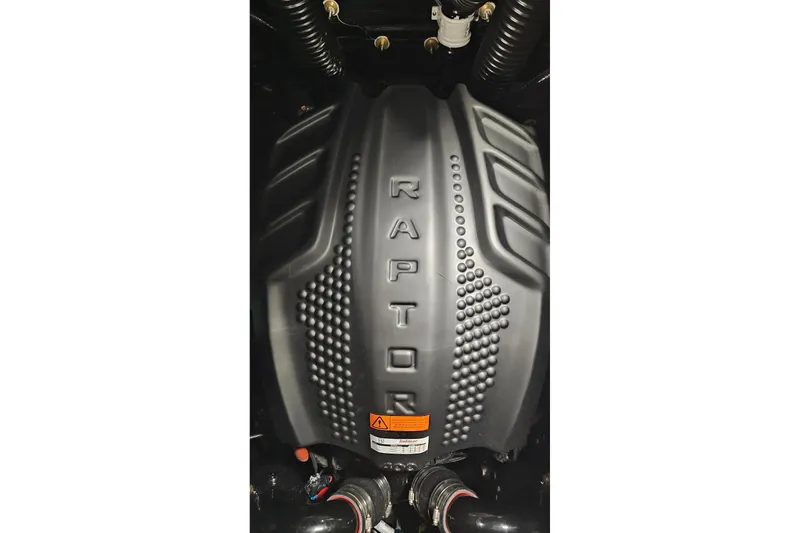 Slide: The Image of 2026 Moomba Max engine cover with "Raptor" branding, featuring textured design elements. - 17