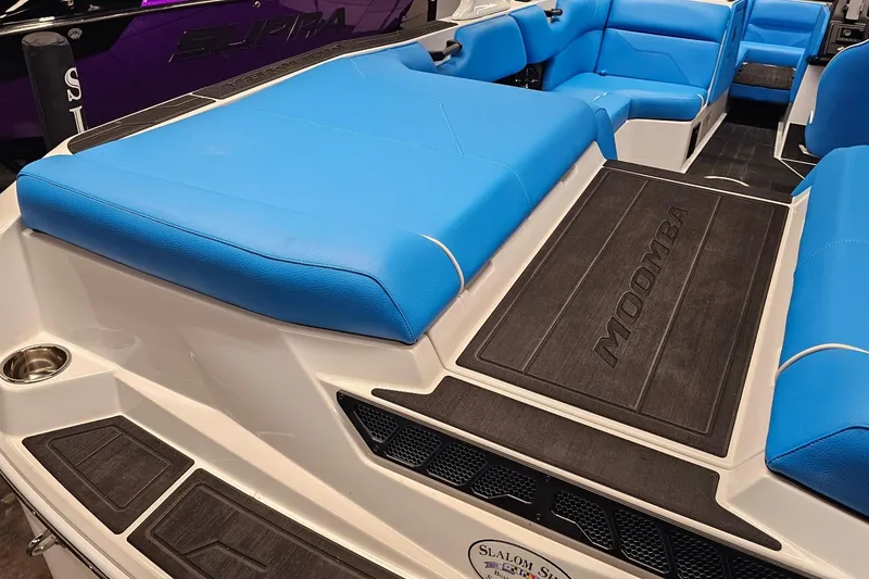 Slide: The Image of 2026 Moomba Max boat interior with blue seating and branded flooring. - 8