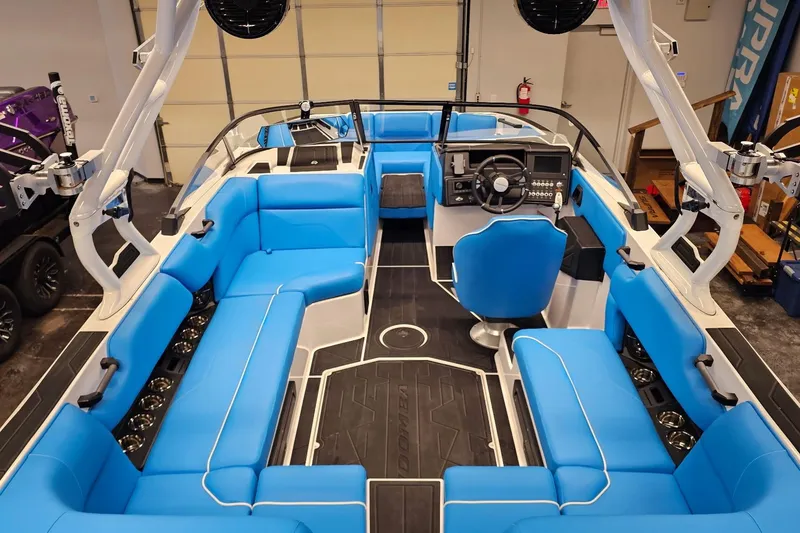 Slide: The Image of 2026 Moomba Max boat interior with blue seating and modern dashboard. - 9