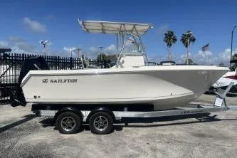 The Image of 2023 Sailfish 220 CC boat on trailer, parked outdoors under clear sky. - 1