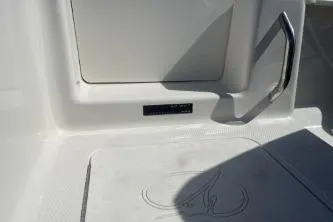 Slide: The Image of 2023 Sailfish 220 CC boat interior with handle and storage compartment. - 13