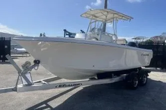 Slide: The Image of 2023 Sailfish 220 CC boat on trailer, parked outdoors under clear sky. - 4