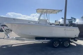 Slide: The Image of 2023 Sailfish 220 CC boat on trailer, side view under clear sky. - 5