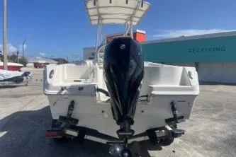 Slide: The Image of 2023 Sailfish 220 CC boat with outboard motor, parked outdoors. - 6