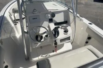 Slide: The Image of 2023 Sailfish 220 CC boat interior with steering console and seating. - 8