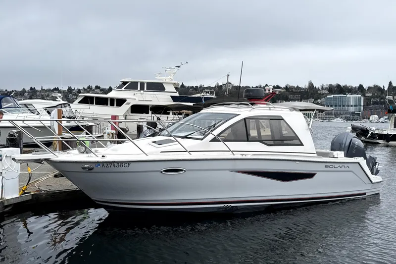 The Image of 2024 Solara S-250 Coupe boat docked at marina, featuring sleek design and modern amenities. - 0