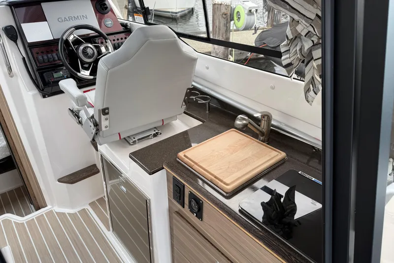 Slide: The Image of 2024 Solara S-250 Coupe interior with helm, cutting board, and modern amenities. - 10