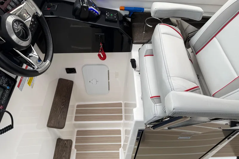 Slide: The Image of 2024 Solara S-250 Coupe interior with steering wheel, control panel, and cushioned seat. - 14