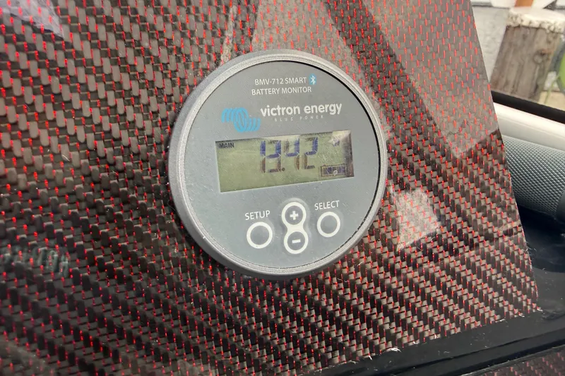 Slide: The Image of Victron Energy battery monitor in 2024 Solara S-250 Coupe, displaying 12.2 volts. - 24