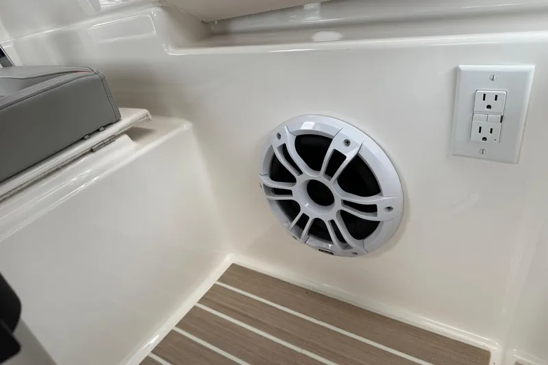 Slide: The Image of 2024 Solara S-250 Coupe interior with speaker and power outlet on sleek paneling. - 32