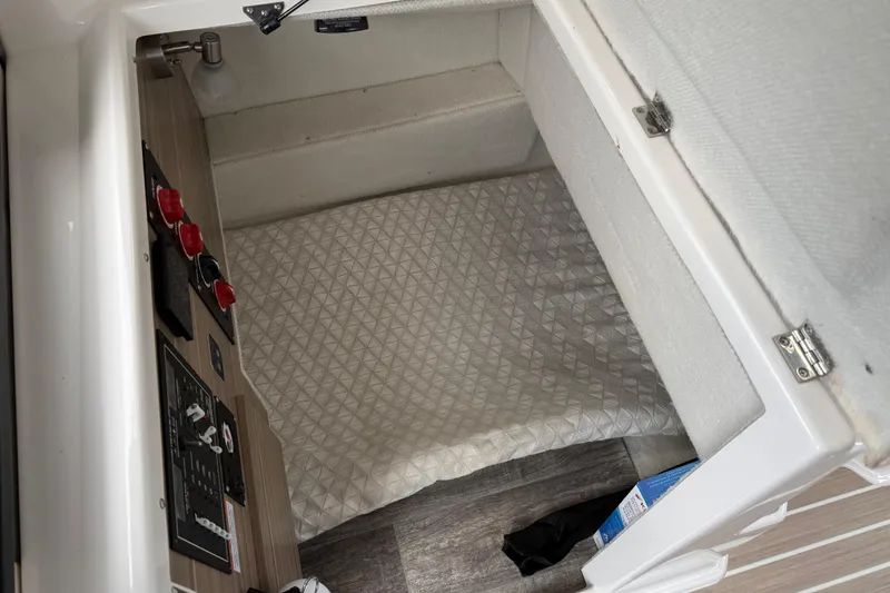 Slide: The Image of 2024 Solara S-250 Coupe interior cabin with control panel and cushioned bedding. - 38