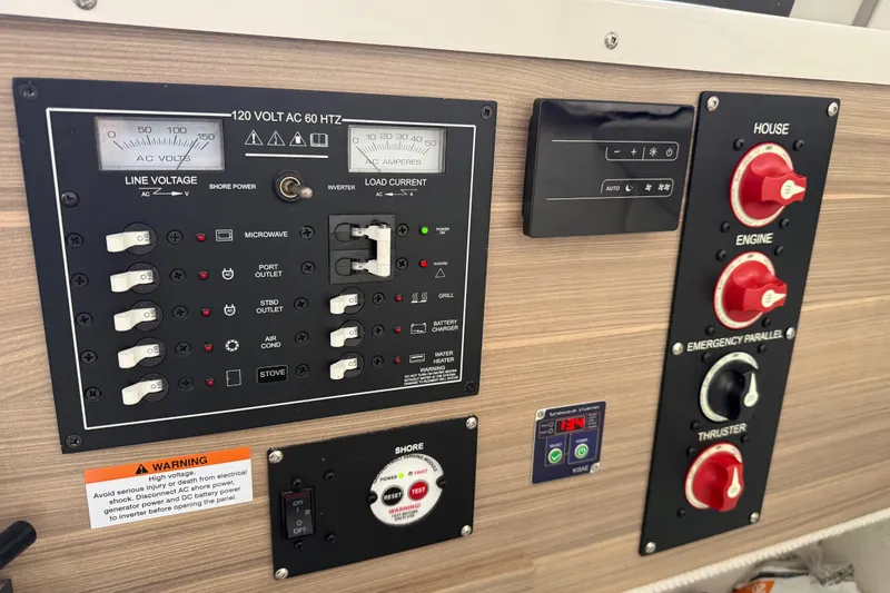 Slide: The Image of Electrical control panel in a 2024 Solara S-250 Coupe, featuring various switches and gauges. - 39