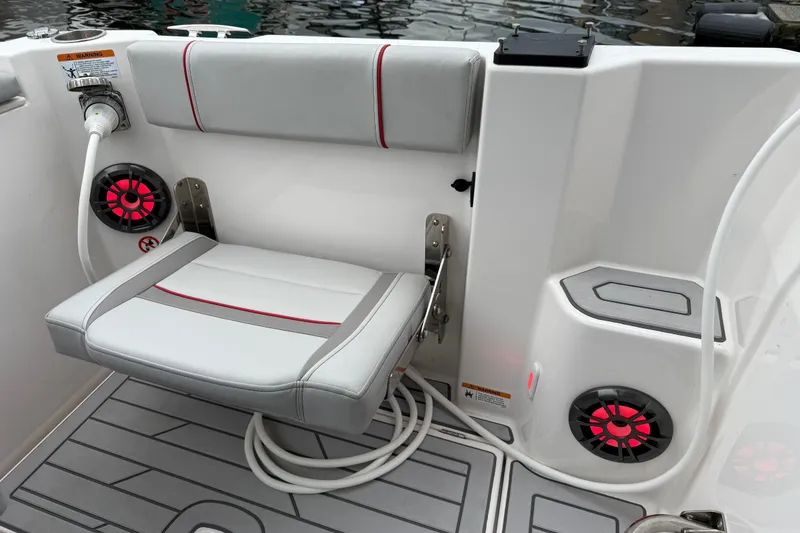 Slide: The Image of 2024 Solara S-250 Coupe boat interior with foldable seat and red-accented speakers. - 4