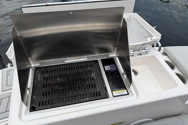Slide: The Image of Outdoor grill and sink on 2024 Solara S-250 Coupe boat, ready for use. - 45