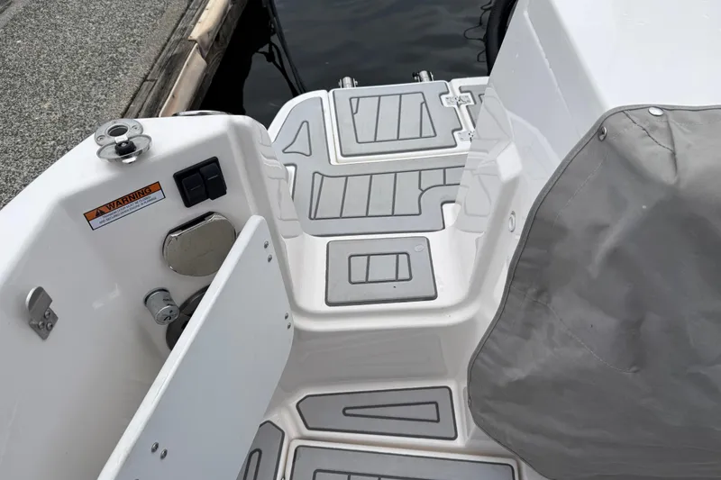 Slide: The Image of 2024 Solara S-250 Coupe boat deck with non-slip surface and covered seating area. - 50