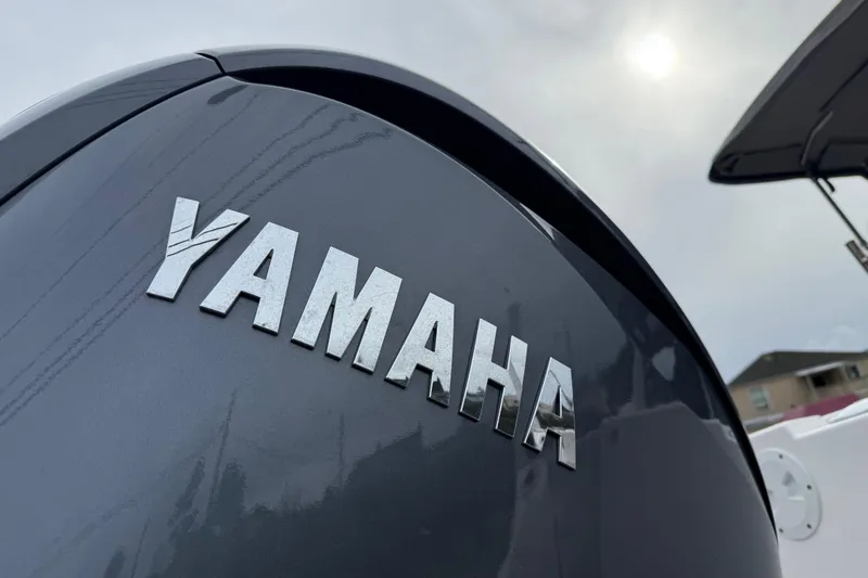 Slide: The Image of Yamaha logo on a 2024 Solara S-250 Coupe, under a cloudy sky. - 54