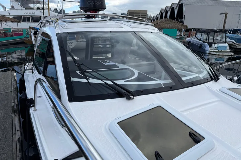 Slide: The Image of 2024 Solara S-250 Coupe boat docked at marina, featuring sleek design and modern equipment. - 57