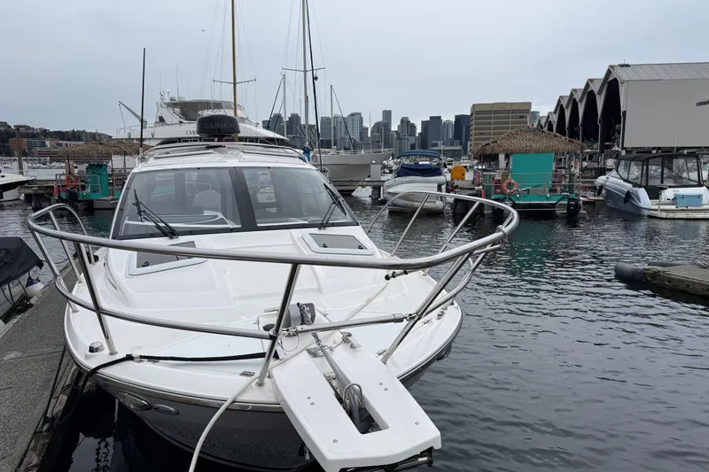 Slide: The Image of 2024 Solara S-250 Coupe docked at a marina with city skyline in background. - 59