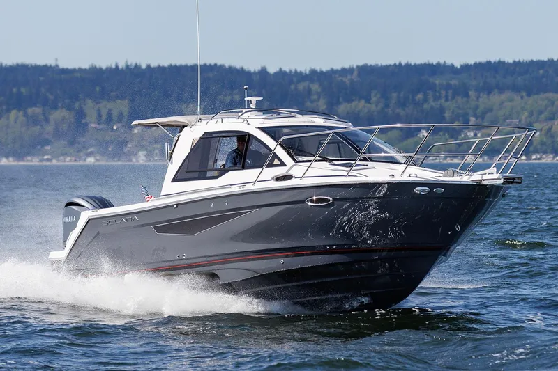 Slide: The Image of Manufacturer Provided Image: 2024 Solara S-250 Coupe cruising on a lake with forested hills in the background. - 66