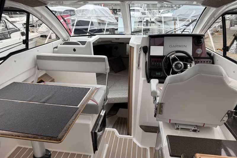 Slide: The Image of Interior of 2024 Solara S-250 Coupe boat with modern helm and seating area. - 9