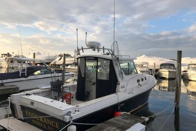 Slide: The Image of 2005 Albin 28 Tournament Express boat docked at marina under cloudy sky. - 10