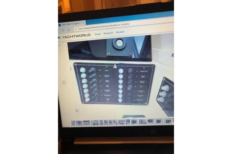 Slide: The Image of Control panel of 2005 Albin 28 Tournament Express boat displayed on a laptop screen. - 13