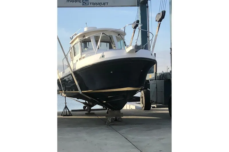 Slide: The Image of 2005 Albin 28 Tournament Express boat on lift at marina. - 6