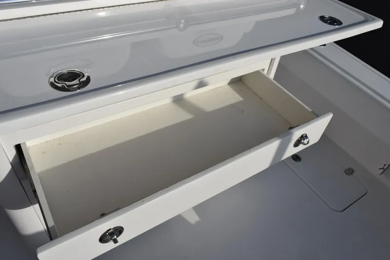 Slide: The Image of Open storage drawer on 2026 Contender 29 Bay boat, showcasing sleek design and functionality. - 11