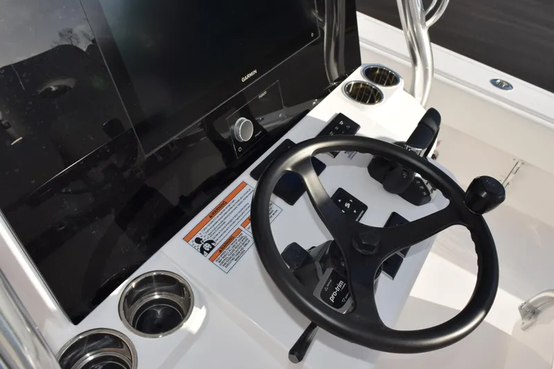 Slide: The Image of Steering console of 2026 Contender 29 Bay boat with Garmin display and controls. - 14