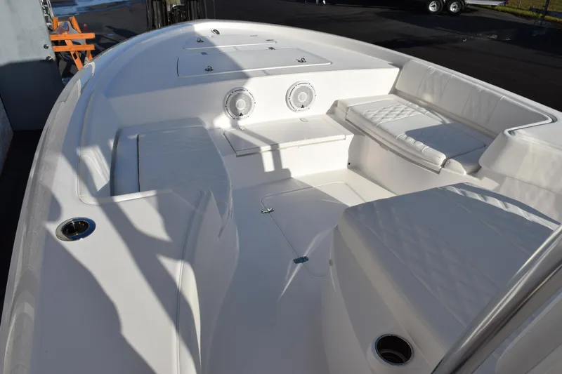 Slide: The Image of 2026 Contender 29 Bay boat interior with white seating and storage compartments. - 15