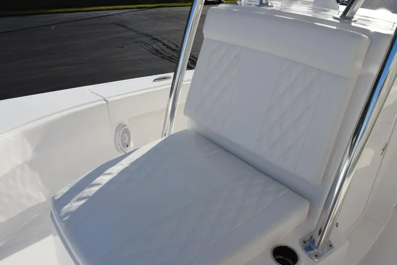 Slide: The Image of 2026 Contender 29 Bay boat with white cushioned seating and stainless steel frame. - 16