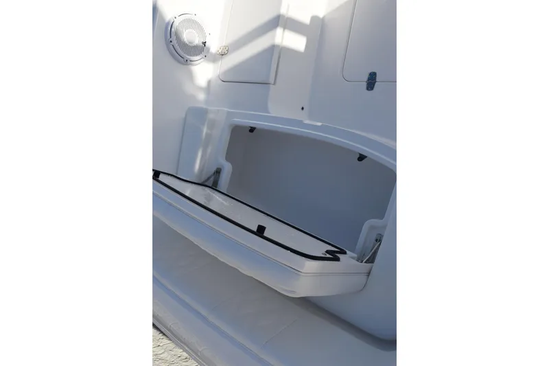 Slide: The Image of Open storage compartment on 2026 Contender 29 Bay boat, featuring sleek white interior design. - 18
