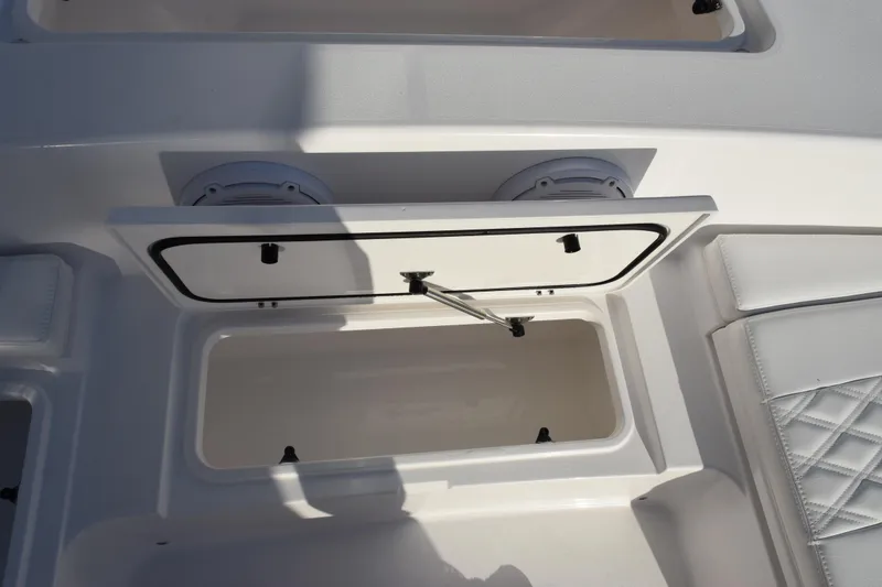 Slide: The Image of 2026 Contender 29 Bay boat storage compartment with open hatch and cushioned seating. - 20