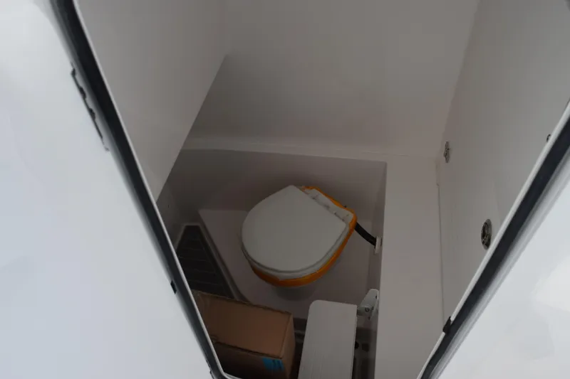 Slide: The Image of 2026 Contender 29 Bay boat interior with compact marine toilet. - 22