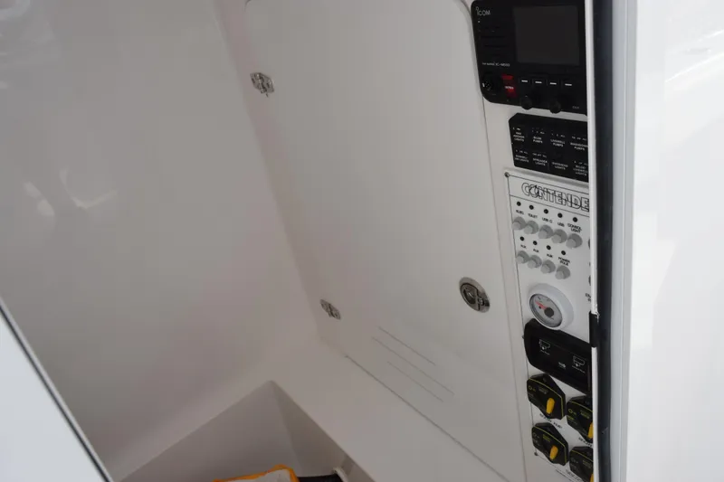 Slide: The Image of 2026 Contender 29 Bay boat control panel with electronic switches and display. - 23