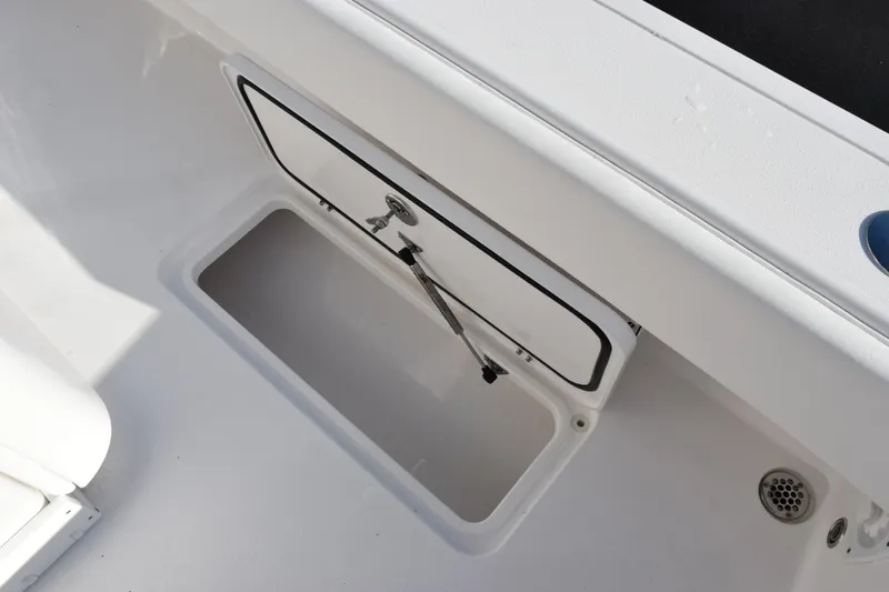 Slide: The Image of 2026 Contender 29 Bay boat storage compartment with open hatch and hydraulic support. - 26