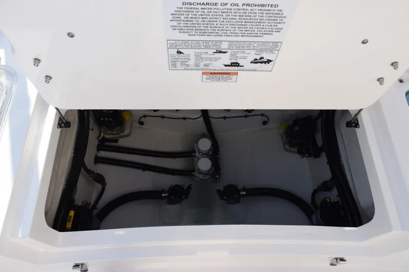 Slide: The Image of 2026 Contender 29 Bay boat engine compartment with visible hoses and components. - 28