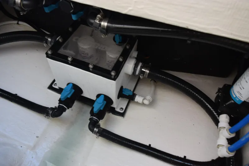 Slide: The Image of Bilge system of 2026 Contender 29 Bay boat with blue valve controls. - 29