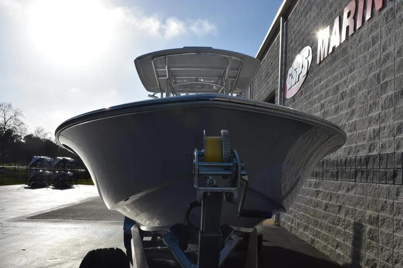 Slide: The Image of 2026 Contender 29 Bay boat on trailer outside marine store. - 3