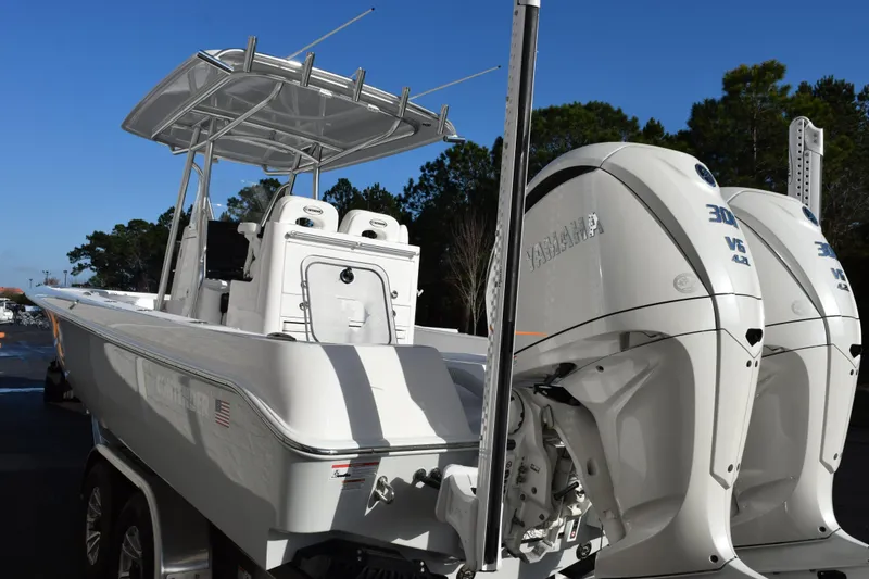 Slide: The Image of 2026 Contender 29 Bay boat with dual Yamaha 300 V6 engines, parked outdoors. - 6