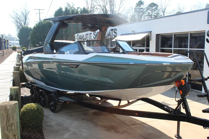 The Image of 2026 Tigé Ultré 25ZX boat on trailer at dealership, showcasing sleek design and modern features. - 1