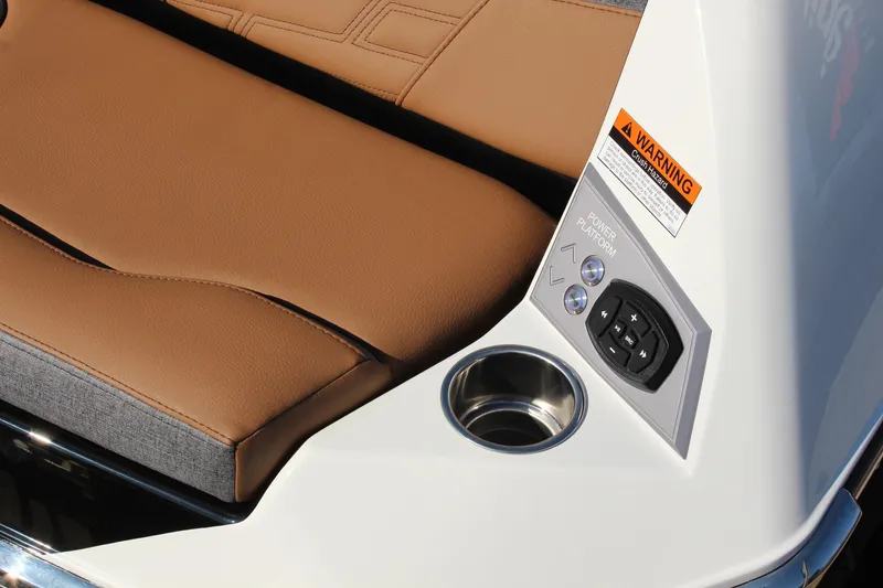 Slide: The Image of 2026 Tigé Ultré 25ZX boat interior with tan seating, control panel, and cup holder. - 10