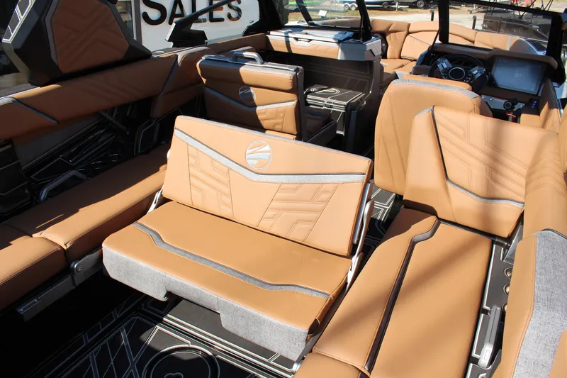 Slide: The Image of 2026 Tigé Ultré 25ZX boat interior with luxurious tan seating and modern dashboard. - 14