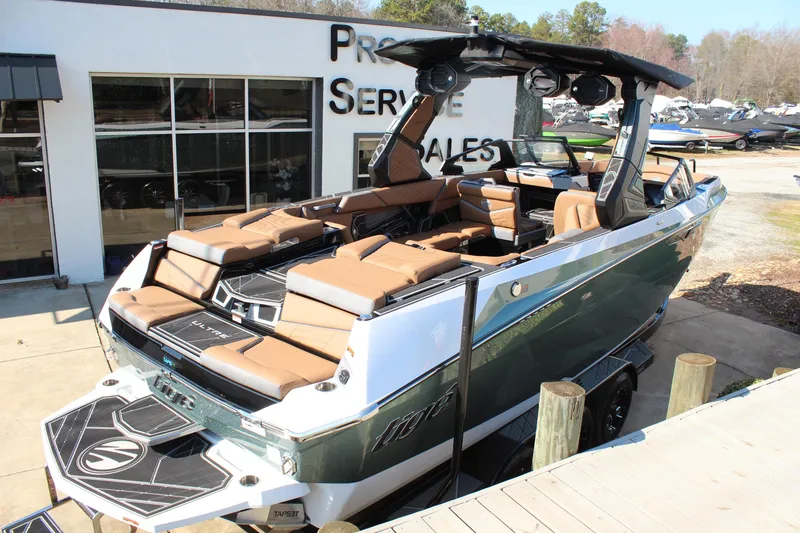 Slide: The Image of 2026 Tigé Ultré 25ZX boat with luxurious seating at a dealership. - 6