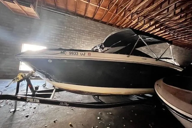 Slide: The Image of 2018 Sea Ray SDX 270 boat on trailer in a dimly lit garage. - 14