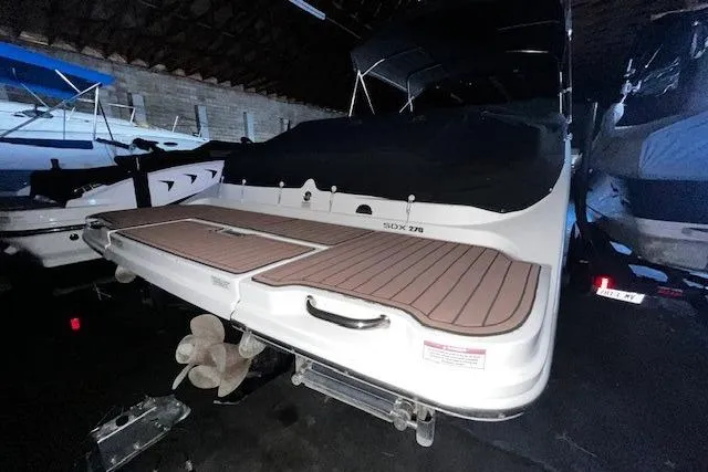 Slide: The Image of 2018 Sea Ray SDX 270 boat in storage, rear view with swim platform. - 15