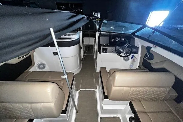Slide: The Image of 2018 Sea Ray SDX 270 boat interior with beige seating and modern dashboard. - 20