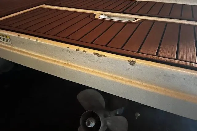 Slide: The Image of 2018 Sea Ray SDX 270 boat with visible wear on the swim platform. - 21