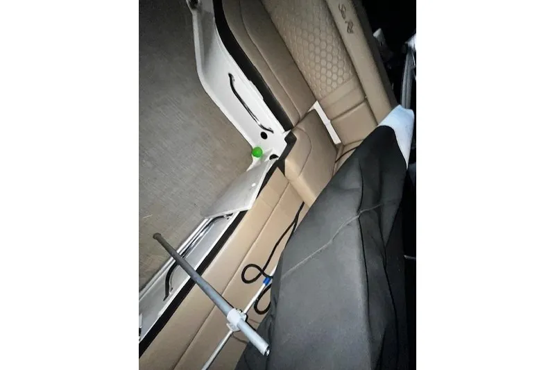 Slide: The Image of 2018 Sea Ray SDX 270 interior with beige seating and equipment. - 26